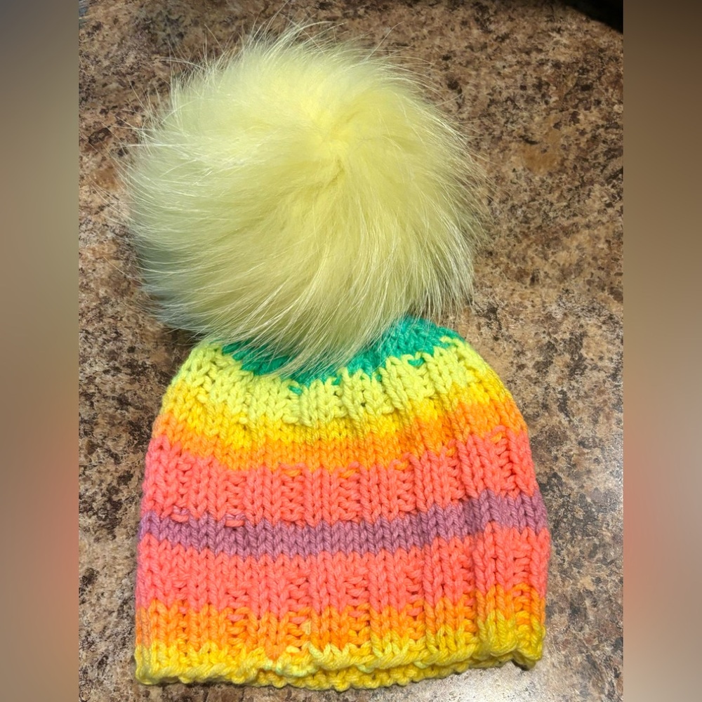 Gorgeous youth hand knitted toque with raccoon luxe pom!